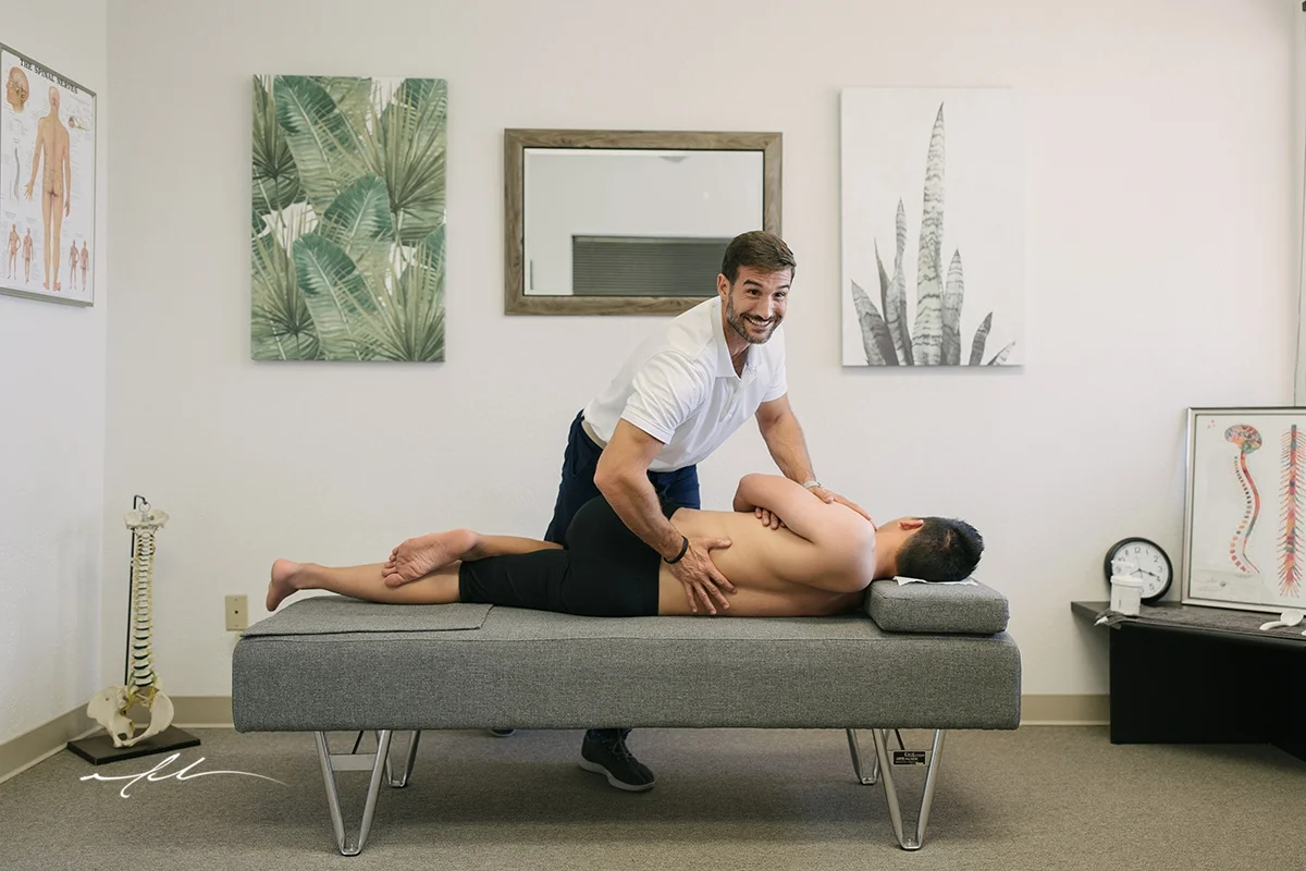 Dr. Nick Deliberato adjusting a patient on a Gonstead table